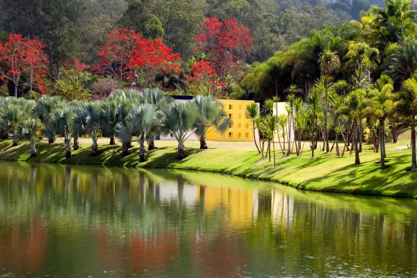 “Jardins coloridos, lago refletindo a paisagem e área verde do Instituto Inhotim em Brumadinho, Minas Gerais.”