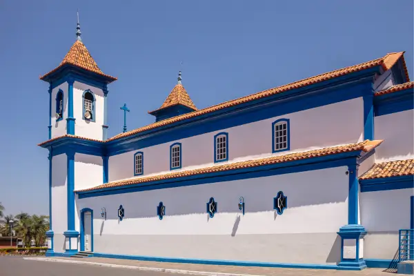 “Igreja histórica de Sete Lagoas, Minas Gerais, com fachada branca e detalhes azuis sob céu claro.”